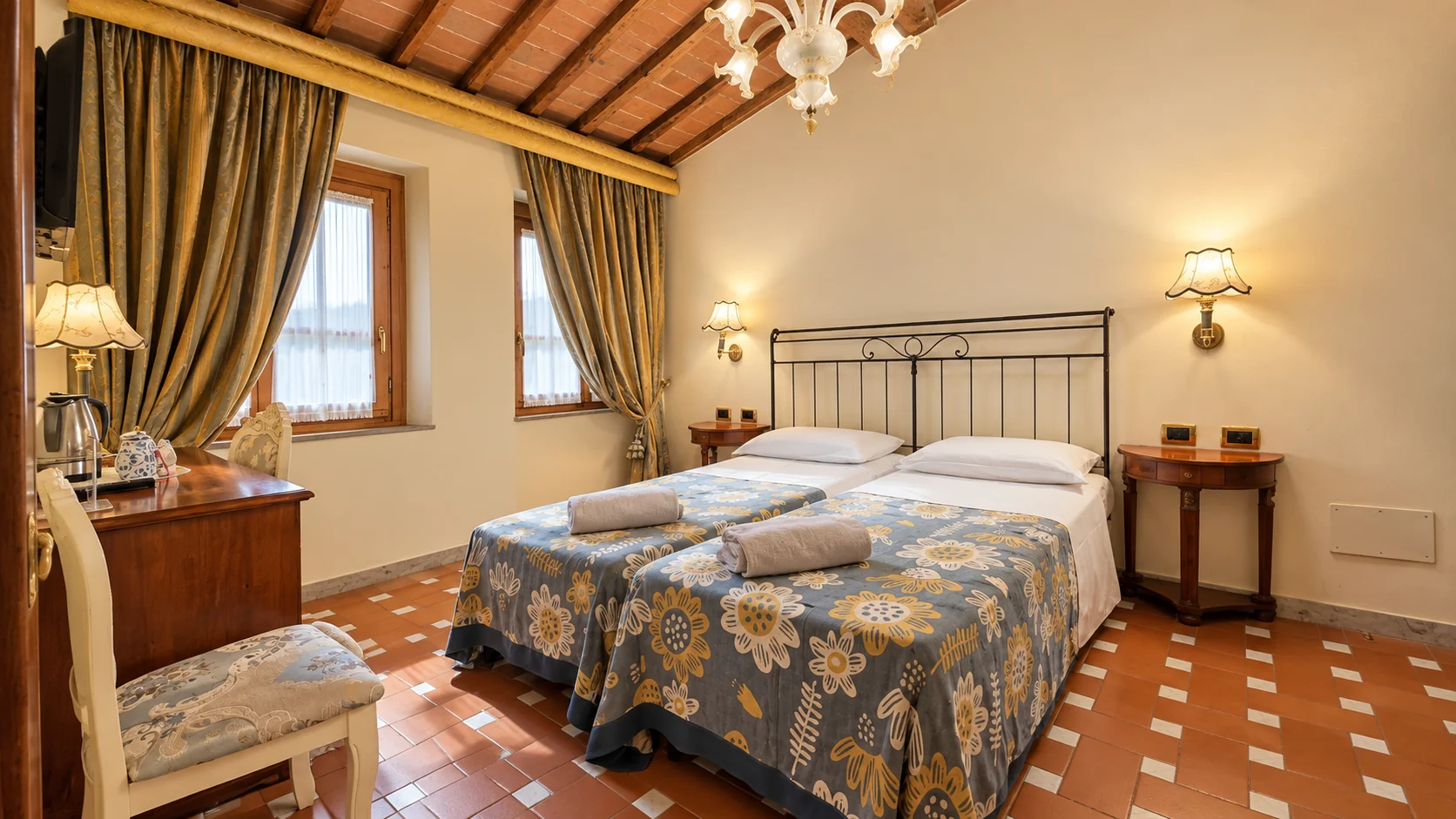A Classic room with twin beds, damask curtains and a terracotta ceiling with exposed beams