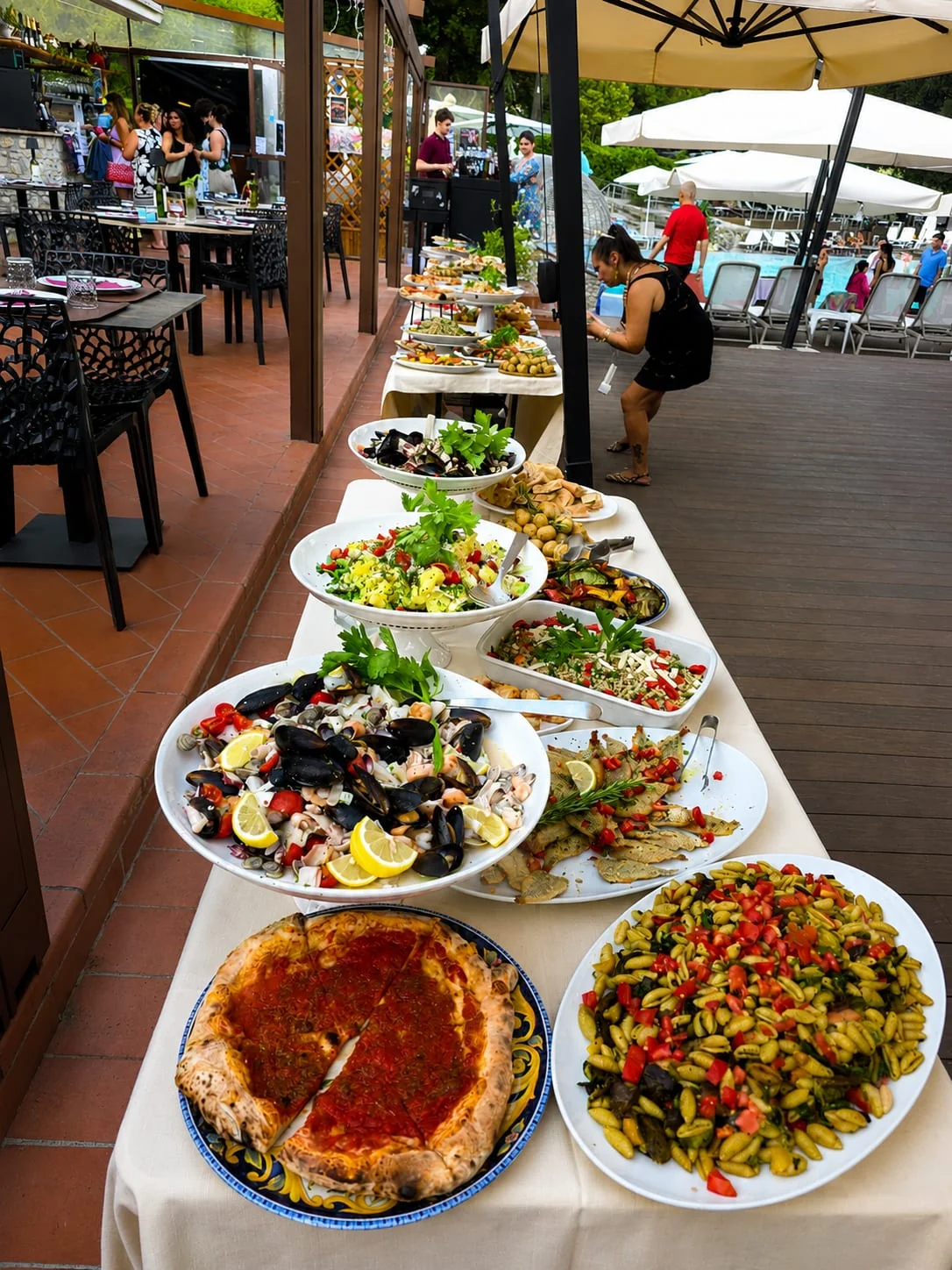 The poolside aperitivo buffet: pizza, cold pasta, seafood and vegetables